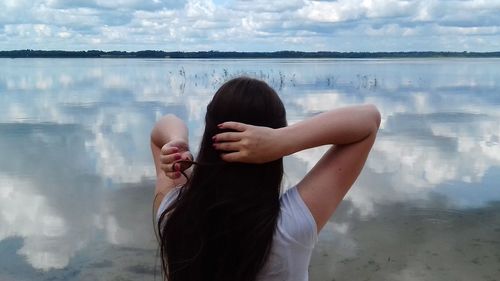 Rear view of woman standing in water