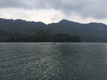 Scenic view of lake against cloudy sky