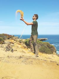 Man throwing sand at beach