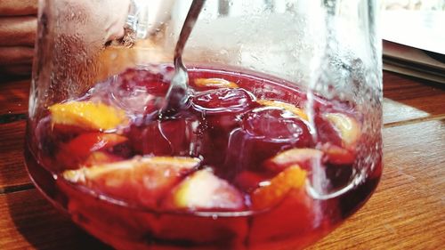 Close-up of fruit slices in drinking glass on table