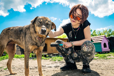 Dog at the shelter. animal shelter volunteer feeding the dogs.