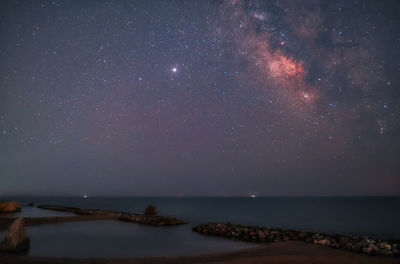 Scenic view of sea against sky at night