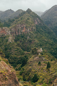 High angle view of valley and mountains against sky