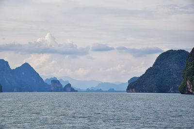 Scenic view of sea and mountains against sky