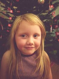 Close-up portrait of girl in christmas tree