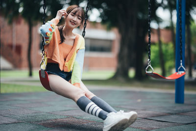 Young woman exercising on slide