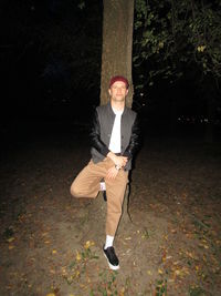 Portrait of smiling young woman standing on land