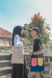 Side view of young couple looking at each other