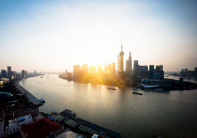 Buildings in city at sunset