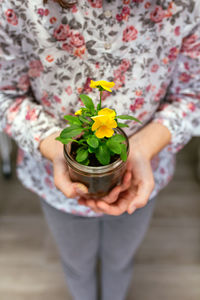 Midsection of woman holding bouquet
