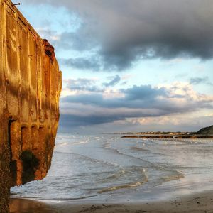 Scenic view of sea against cloudy sky