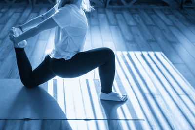Low section of woman exercising in gym