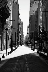 Empty alley amidst buildings in city