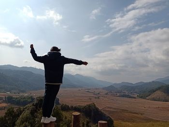 Full length of man standing on mountain against sky