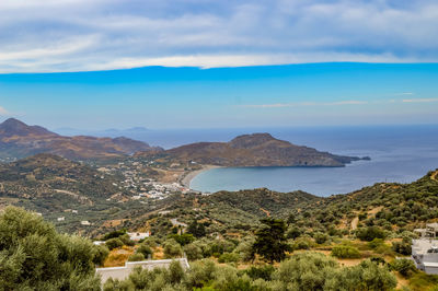 Scenic view of sea and mountains against sky