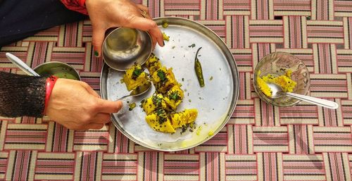 High angle view of woman preparing food on table