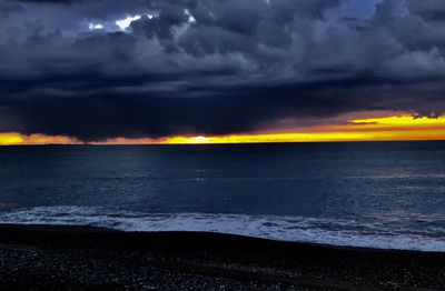 Scenic view of sea against storm clouds