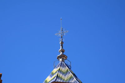 Low angle view of cross against clear blue sky