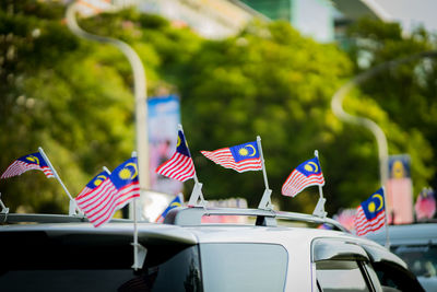 Malaysian flags on cars in city