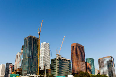 Low angle view of modern buildings against clear sky