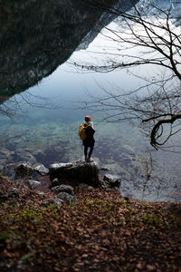 Woman standing on rock overlooking landscape