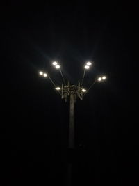 Low angle view of illuminated street light against sky