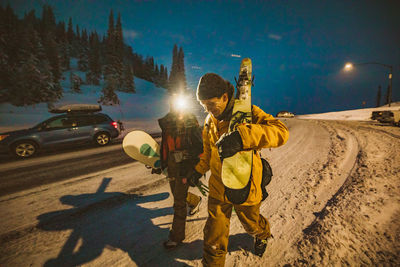 Couple smiling as they end their long ski day at dusk