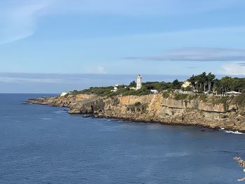 Scenic view of sea and buildings against sky