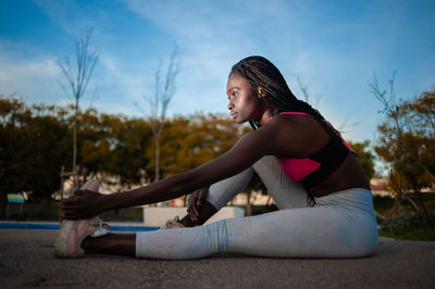 Side view of woman exercising outdoors