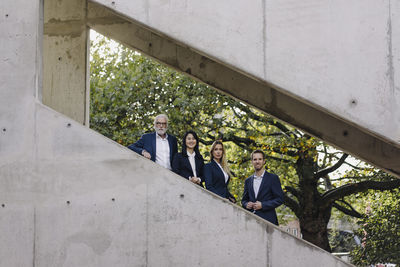 Portrait of confident business people on exterior stair