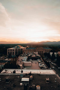 High angle view of road by buildings against sky during sunset