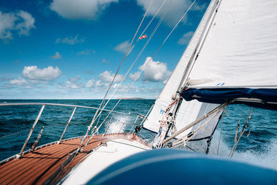 Sailboat sailing in sea against sky