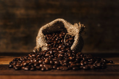 Fresh roasted coffee beans with burlap sack on a wooden table