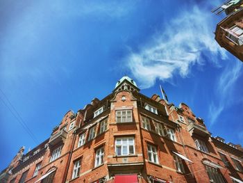 Low angle view of building against blue sky in city