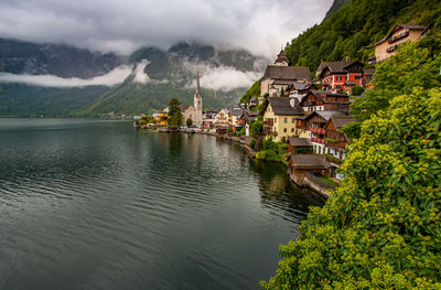 Panoramic view of lake and buildings against sky