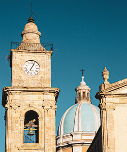 Low angle view of clock tower against sky