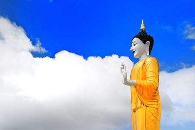 Low angle view of statue against temple against sky