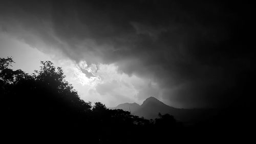 Low angle view of silhouette mountain against sky