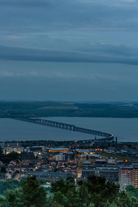 High angle view of buildings by sea against sky