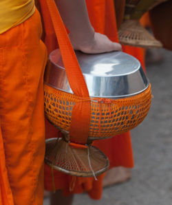 Midsection of woman wearing traditional clothing walking on road