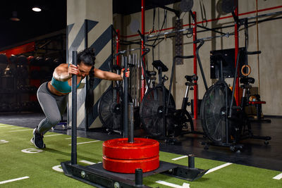 Low section of man exercising in gym