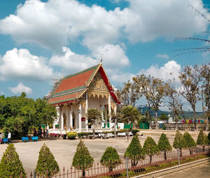 Temple by building against sky