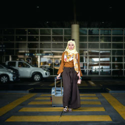 Woman with luggage walking at airport