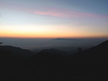 Scenic view of silhouette mountains against sky at sunset
