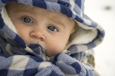 Close-up portrait of baby boy wearing hooded shirt during winter