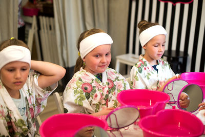 High angle view of girls sitting at table in spa