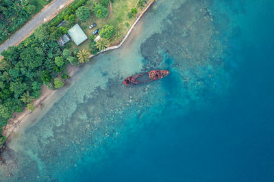 Abandoned broken sunken old ship that ran aground. drone view. tropical coast of sanma, vanuatu