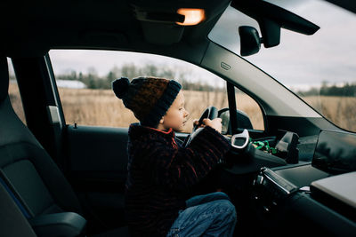 Boy sitting in car