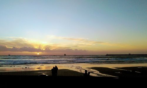Scenic view of beach against sky during sunset