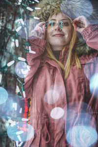 Portrait of woman wearing sunglasses standing outdoors